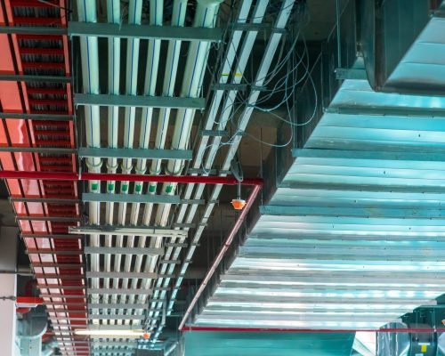 Mechanical and electrical services on the ceiling in a construction site.
